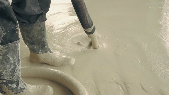 Pouring concrete floor in family house. Anhydrite is optimal binder for production of anhydrite floor screeds. Used as basis for self-leveling poured floors. Construction industry works on building