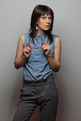 Picture of Young woman wearing modern eyeglasses anf thinking isolated on grey background