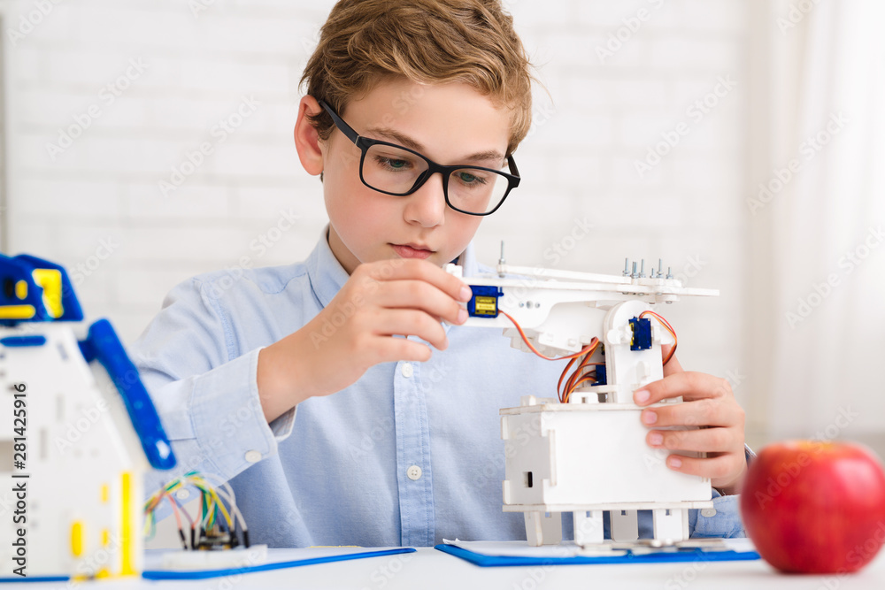 Poster smart boy making diy robot at stem lab