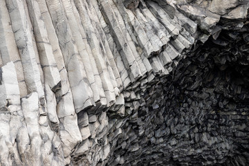 Reynisfjara Beach, Vik Village, Sudurland, Iceland, Europe. Amazing landscape with basalt rock formations and Troll Toes on Black beach Reynisfjara