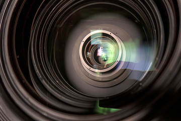 close up of a television lens on a dark background