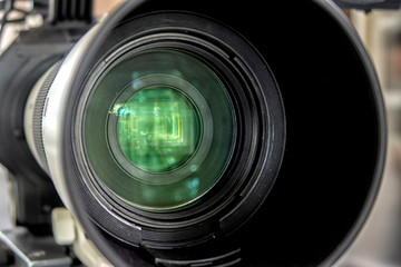 close up of a television lens on a dark background