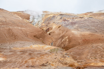 Hverir Namafjall colorful geothermal place in Iceland. Fumaroles volcanic boiling mud pots, surrounded by sulfur hot springs.