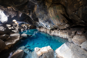 Grjotagja volcanic cave with blue hot thermal water near Lake Myvatn. The geothermal cave, areas of...