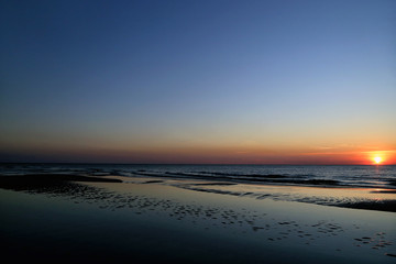 Sandy beach on the Baltic Sea on the Curonian Spit in Lithuania in the evening during sunset.
