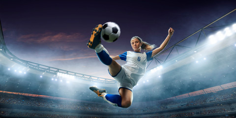 Female Soccer player in action on a professional soccer stadium. Girl playing soccer