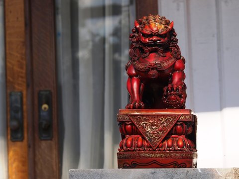 A foo dog or foo lion often found in pairs on the front porch of Asian American homes