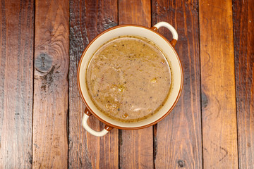 Traditional Slovakian beef goulash with peppers and potatoes on wood table. Top view food.