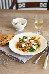 Mixed vegetable stir fry with mushrooms and cottage cheese. Tender mushroom stir fry served in a white plate with white wine