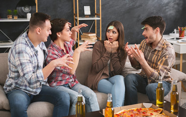 Friends playing forehead game at home party