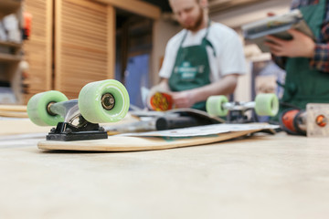 Two professional builders carpenters make skateboards with an exclusive design. Unique handmade concept. Copyspace