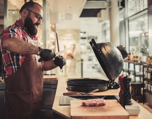 Chef sharping knive for a steak in a restaurant
