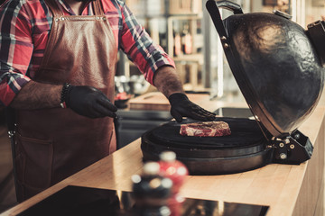 Chef grilling steak in a restaurant