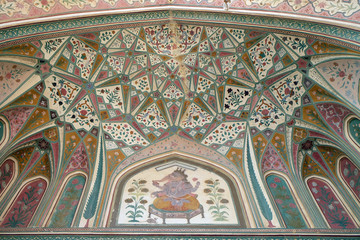 Fototapeta na wymiar Beautiful ornament on wall of palace in Amber Fort in Jaipur, Rajasthan, India