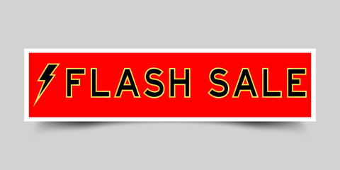 Red sticker label with word flash sale and thunder icon on gray background