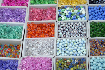 Fototapeta na wymiar Multi colored beads and tools for making jewelry and crafts