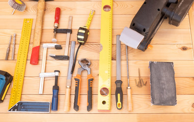 View of a wooden table with all the tools in order. Meter, screwdriver,rasp,pincers.