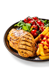 Grilled chicken fillet with french fries on white background