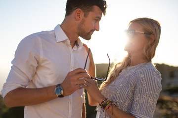 Happy young couple smiling in sunset together