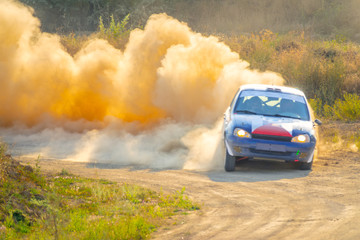 Obraz na płótnie Canvas Color Rally Car Passes Turn of the Road
