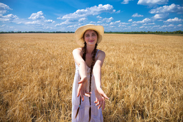 Naklejka premium Come with me, young beautiful girl holds the hand of a man in a wheat field