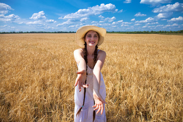 Come with me, young beautiful girl holds the hand of a man in a wheat field