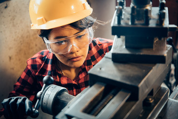 Asian beuatiful woman working with machine in the factory engineer and working woman concept or woman day