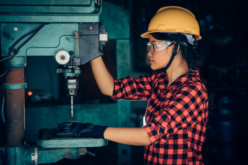 Asian beuatiful woman working with machine in the factory engineer and working woman concept or...