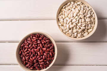 Assortment of peas, lentils, beans and legumes over white wooden background. Top view.