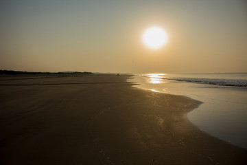 sun, shimmering sand and a lonely man on the beach