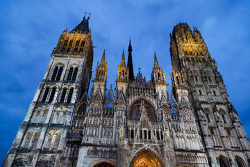 Fototapeta premium Rouen Cathedral (Cathedrale de Notre-Dame) in Rouen, capital of Haute-Normandie. The facade of the Gothic church building in blue hours. Travel France.