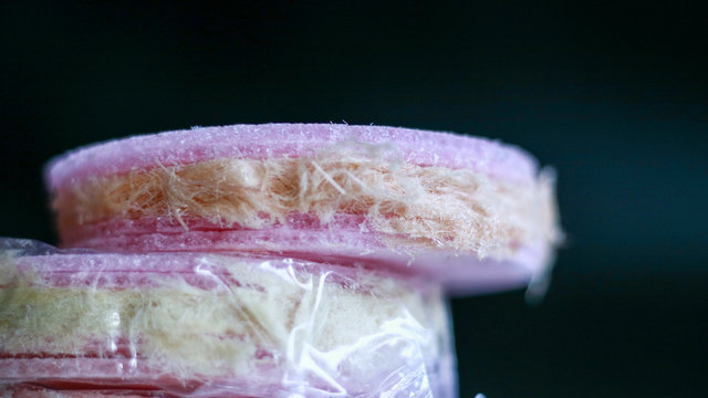 Rambut Nenek or Arumanis (Cotton Candy with Crackers) on black background. Indonesian Traditional Food.