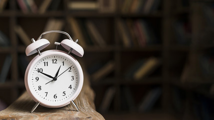 Close-up of a alarm clock on wooden desk