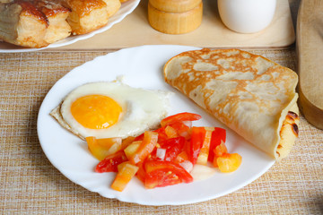 Breakfast, scrambled egg with vegetables, pancake and pastries