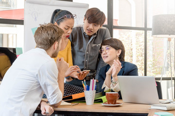 Group of four creative worker brainstorm together in office, New style of workspace.
