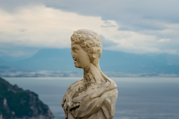 Fototapeta na wymiar Beautiful statue from the belvedere, the so-called Terrazza dell'infinito, The Terrace of Infinity seen on the sunset, Villa Cimbrone, Ravello village, Amalfi coast of Italy