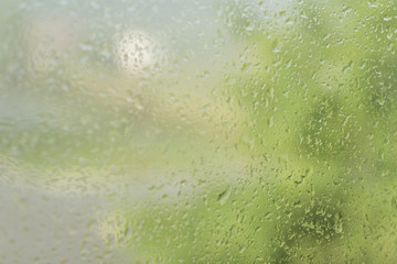 Raindrops on the window glass with blurred background.