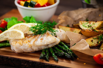 Fish dish - fried fish fillet with fried potatoes and vegetables