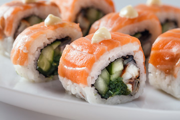 Sushi with salmon on white plate