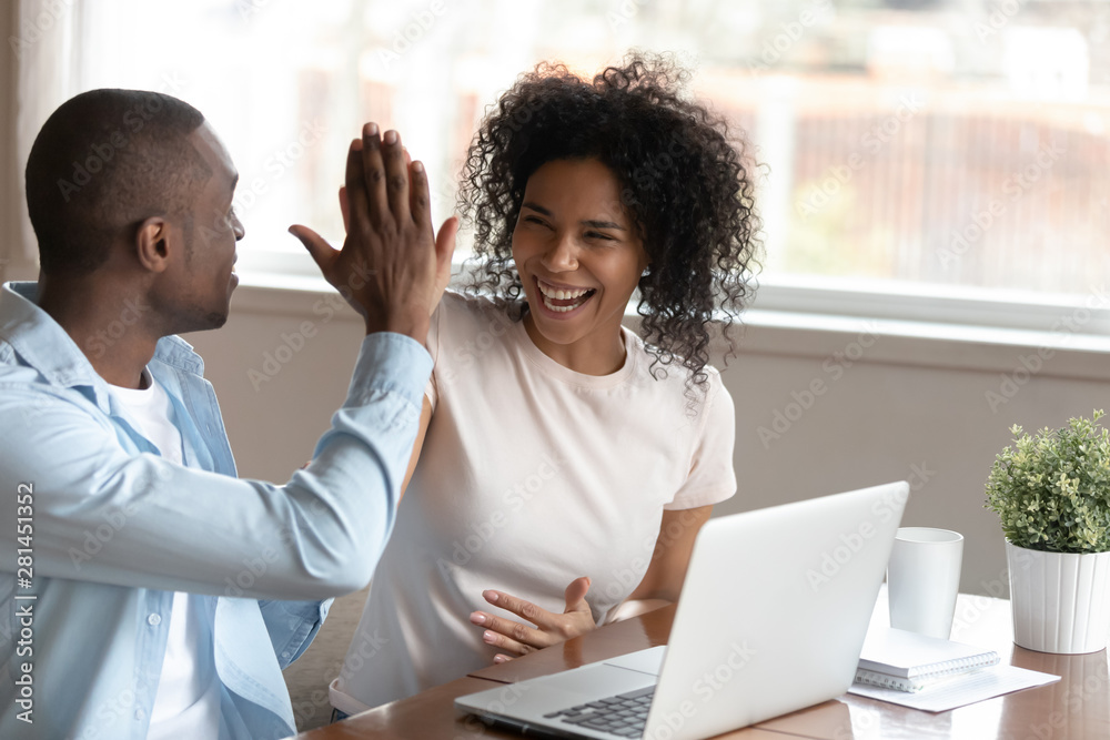 Wall mural happy african couple celebration victory feels overjoyed