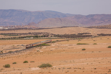 Passenger train in desert valley