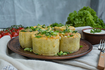 Squash stuffed with minced meat, vegetables and sprinkled with hard cheese. Side view.