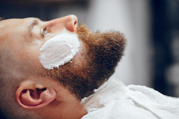 Man with a beard. Hairdresser with a client.