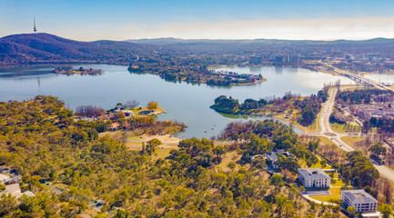 Panorama view of Canberra, the capital city of Australia, looking north over Lake Burley Griffin with Black Mountain and Telstra Tower to the left and Commonwealth Bridge at right - obrazy, fototapety, plakaty