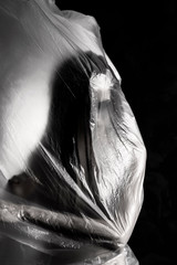 Slim girl dressed only in underwear emotionally posing, wrapped in fluttering in the wind and...