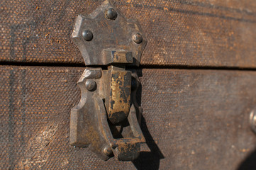 Old weathered retro vintage grunge suitcase handle and metal latch lock closeup