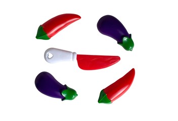 Knife, eggplant and red chili pepper close up.