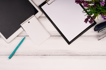 Planner on the wooden working table with computer. Blank white paper on working desk