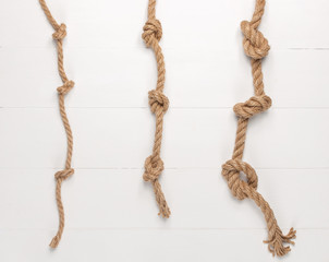 Jute rope on white wooden background.