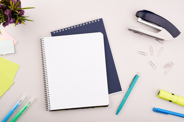 Planner on the grey wooden working table. Blank white paper on working desk